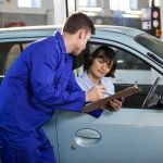 Mechanic showing the quotation to a customer at the repair garage